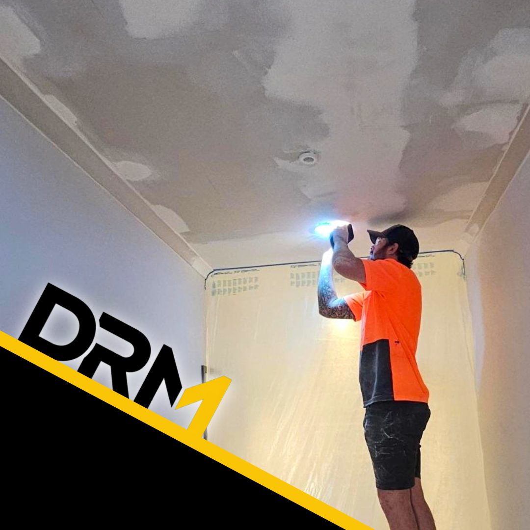 Set ceiling repairs being checked under a work light before painting
