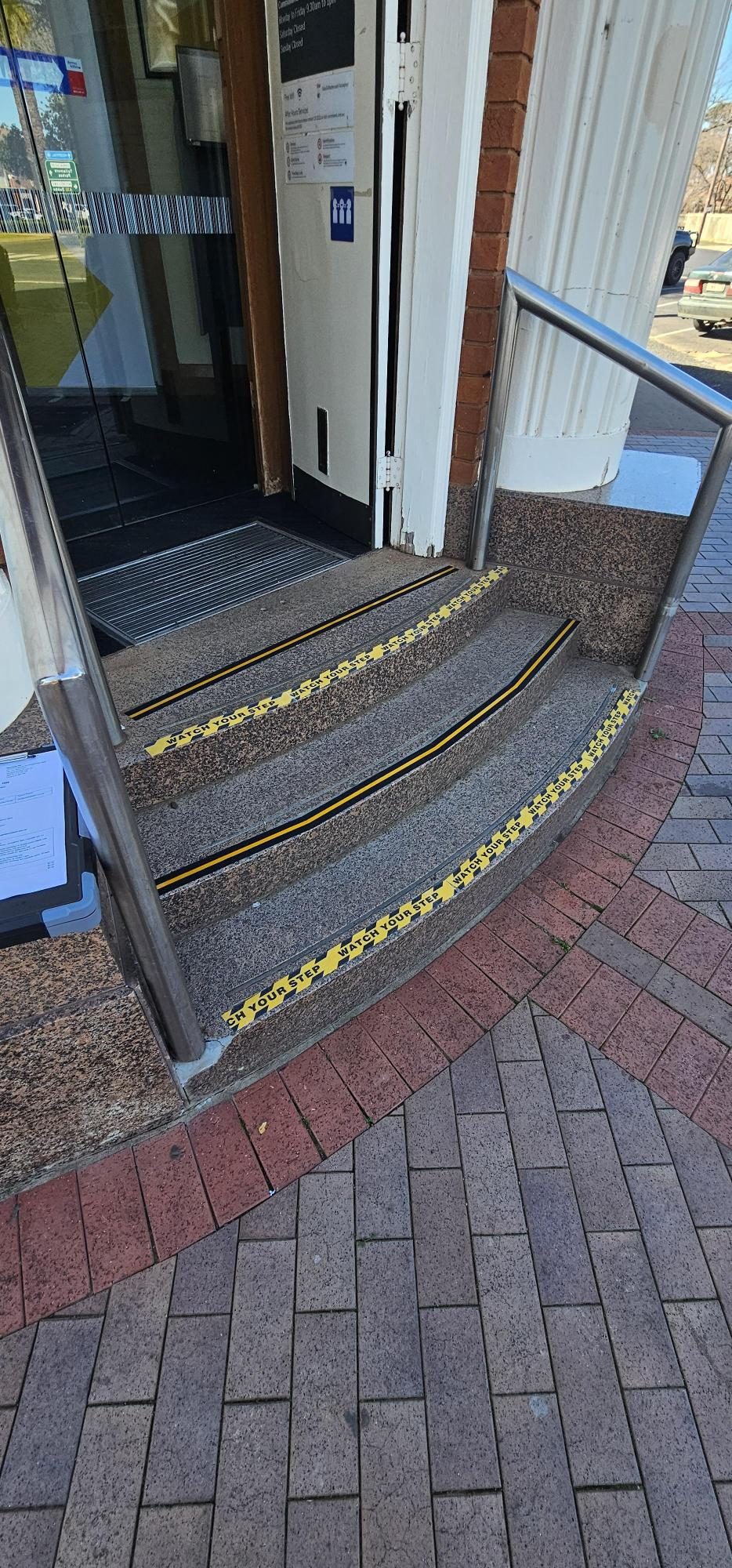 After: Commercial entrance step-edge visibility markings, completed under subcontract