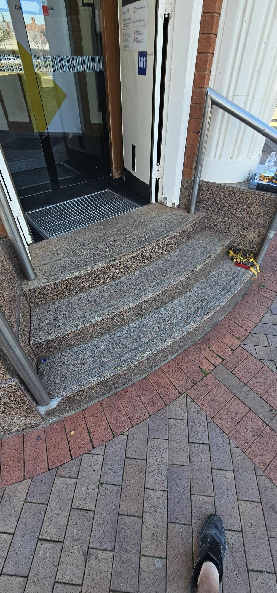 Before: Commercial entrance step-edge visibility markings, completed under subcontract