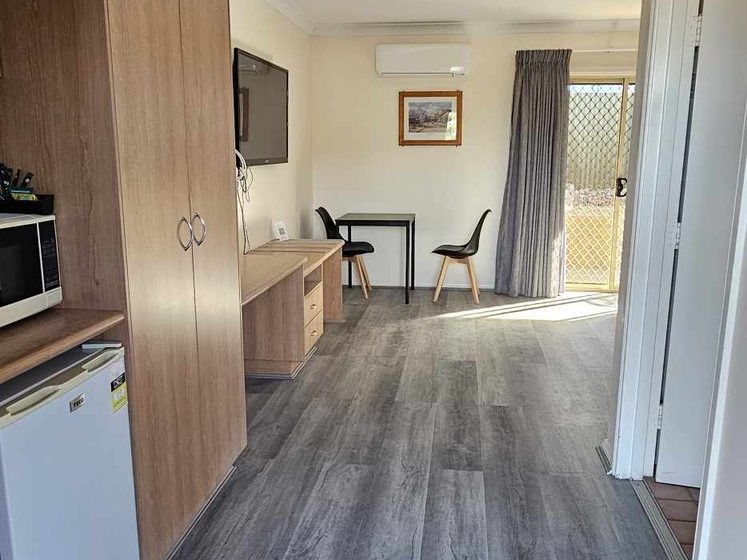 Completed flooring through a corridor and kitchenette