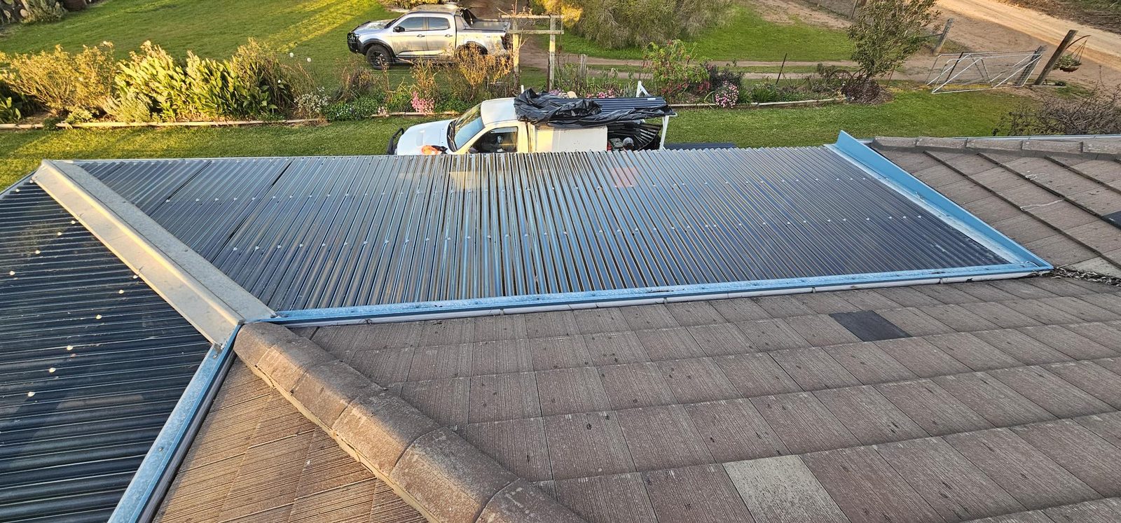 After: Damaged polycarbonate sheets replaced and the patio roof completed
