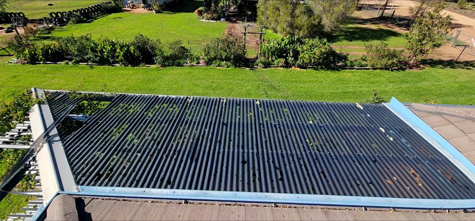 Before: Damaged polycarbonate sheets replaced and the patio roof completed